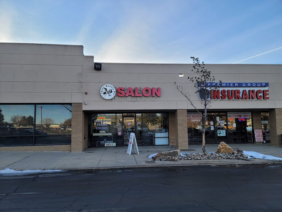 The storefront at Sixth & Sable Plaza with the red SALON sign